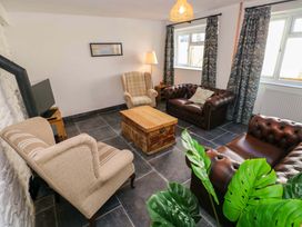 A living room with sofas and a coffee table at Coach House Cottage 