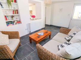A living room with a sofa and coffee table at Coach House Cottage
