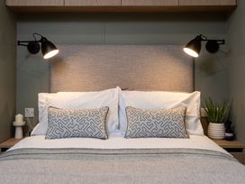 A bedroom with a bed and bedside lamps at Arlington 40 x 14 Two Bed