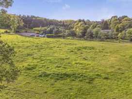 An outdoor scene with a grassy area and trees at The Pines 2 Bedrooms Delamere