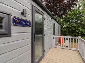 An entrance with door and sign at The Pines 2 Bedrooms in Delamere