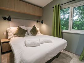 A bedroom with a bed and pillows at The Pines 2 Bedrooms in Delamere