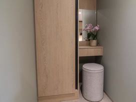 A dressing room with a vanity and a plant at The Pines 2 Bedrooms Delamere