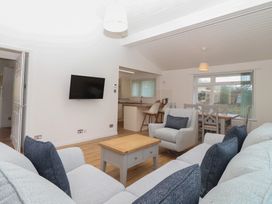 A living room with a sofa and coffee table at Harcombe House Bungalow 25 in Chudleigh