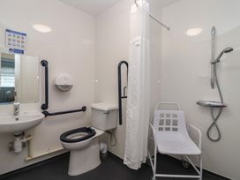 A bathroom with a toilet, sink, and shower at Harcombe House Bungalow 25 Chudleigh