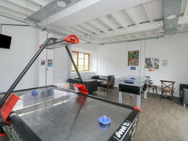 A game room with air hockey and foosball tables at Harcombe House Bungalow 25 Chudleigh