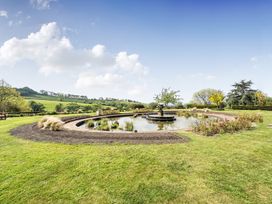 A garden with a pond and water fountain at Harcombe House Bungalow – Pet Friendly with Wet Room, Chudleigh