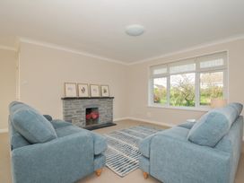 A living room with a fireplace and window at 42 Little Trelyn in Wadebridge