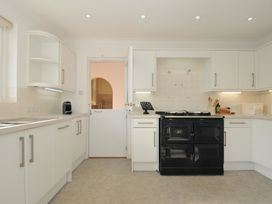 A kitchen with cabinets and stove at 42 Little Trelyn in Wadebridge