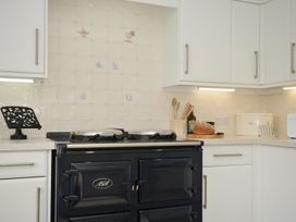 A kitchen with an AGA stove and countertop appliances at 42 Little Trelyn Wadebridge