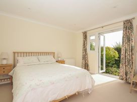 A bedroom with a bed and door leading to the garden at 42 Little Trelyn Wadebridge