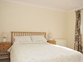 A bedroom with a bed and bedside tables at 42 Little Trelyn in Wadebridge