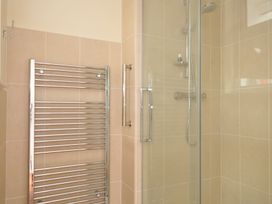 A bathroom with a shower and a towel rail at 42 Little Trelyn in Wadebridge