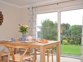 A dining room with a table set for breakfast at 42 Little Trelyn in Rock