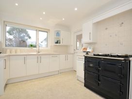 A kitchen with a stove and sink at 42 Little Trelyn in Rock