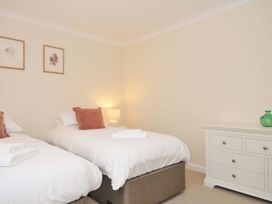 A bedroom with two beds and a dresser at 42 Little Trelyn in Rock