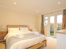A bedroom with a bed and two bedside tables at 42 Little Trelyn Rock