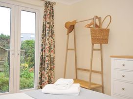 A bedroom with a clothes rack and towels at 42 Little Trelyn in Rock