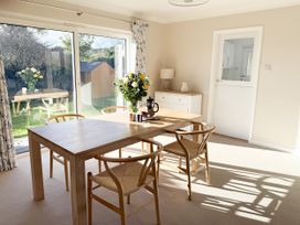 A dining room with a table and chairs at 42 Little Trelyn Rock