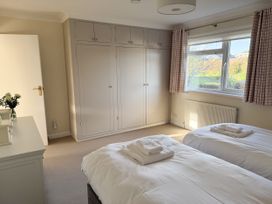 A bedroom with two beds and a wardrobe at 42 Little Trelyn in Rock