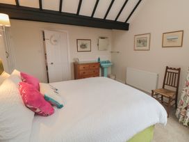 A bedroom with a bed and dresser at Iveridge Sandsend