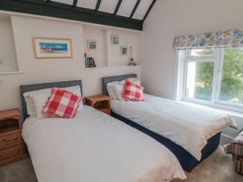 A bedroom with two beds and artwork on the wall at Iveridge in Sandsend