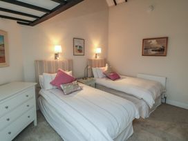 A bedroom with two beds and a chest of drawers at Iveridge in Sandsend