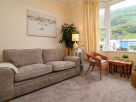 A living room with a sofa and a chair at Zide the Zea in Hele Bay, Ilfracombe