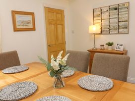 A dining room with a table and chairs at Zide the Zea Hele Bay, Ilfracombe