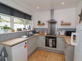 A kitchen with a sink and oven at Zide the Zea in Hele Bay, Ilfracombe