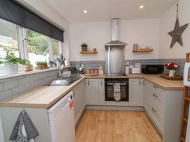 A kitchen with modern appliances and wooden countertops at Zide the Zea in Hele Bay, Ilfracombe