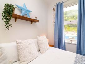 A bedroom with bed and star decoration at Zide the Zea, Hele Bay, Ilfracombe
