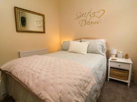 A bedroom with a bed and nightstand at Zide the Zea in Hele Bay, Ilfracombe