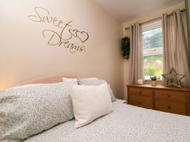 A bedroom with a bed and dresser at Zide the Zea, Hele Bay, Ilfracombe