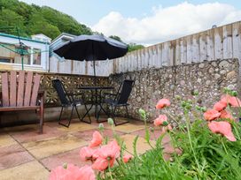 A patio area with a table and chairs at Zide the Zea, Hele Bay, Ilfracombe