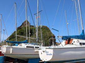Boats docked at a harbor with a hill in the background at Zide the Zea, Hele Bay, Ilfracombe