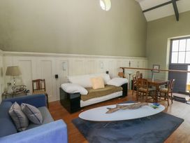 A sitting room with sofas a coffee table and a dining table at Zoar Chapel in Carew