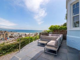 An outdoor seating area overlooking the sea at Harbour House in Looe