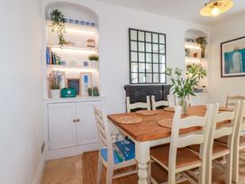 A dining room with a table and chairs at Harbour House in Looe