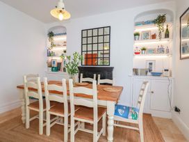 A dining room with a table and chairs at Harbour House in Looe