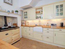 A kitchen with cabinets and a sink at Harbour House in Looe