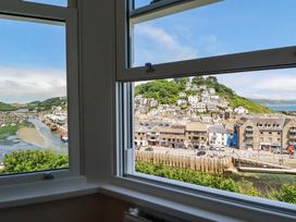 A view from a window showing buildings and a river at Harbour House in Looe