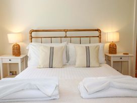 A bedroom with a bed and lamps at Harbour House in Looe