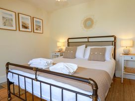 A bedroom with a double bed and nightstands at Harbour House in Looe