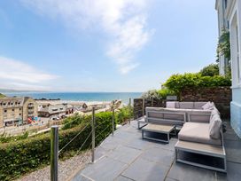 An outdoor seating area with sea view at Harbour House in Looe
