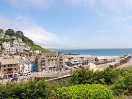 A coastal scene with houses and beach at Harbour House in Looe