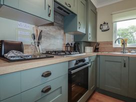 A kitchen featuring appliances and cabinetry at Lodge 9 - Lamorna, Tregolds near St Merryn