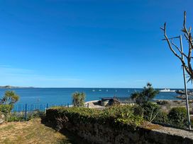 A view of the sea with sailboats and a pier at 1 Penrose Court Penzance