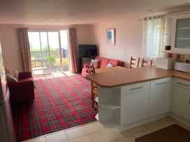 A living room with a sofa and table at 1 Penrose Court in Penzance