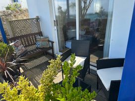 An outdoor patio with seating and plants at Tide Watch in Penzance